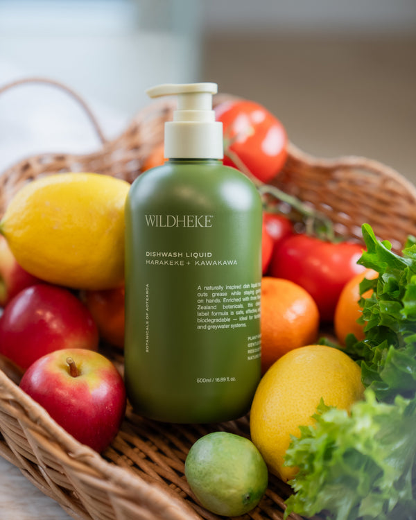 Wildheke dishwash liquid in a kitchen setting with fresh fruit and natural ingredients